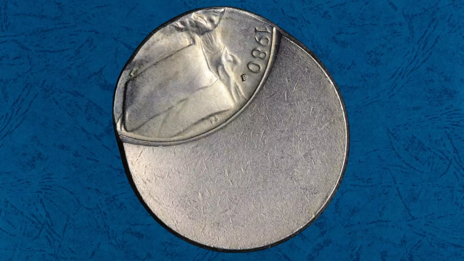 1980 Jefferson nickel off-center strike error showing design shifted to one side with blank crescent area and visible date